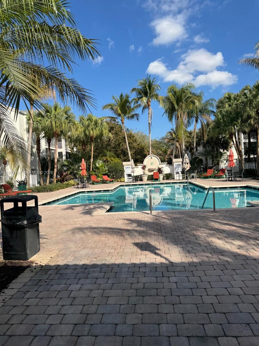 5760 Rock Island Road, Unit 304 Tamarac, FL 33319 - Photo 36 of 40 a view of a yard with cars park