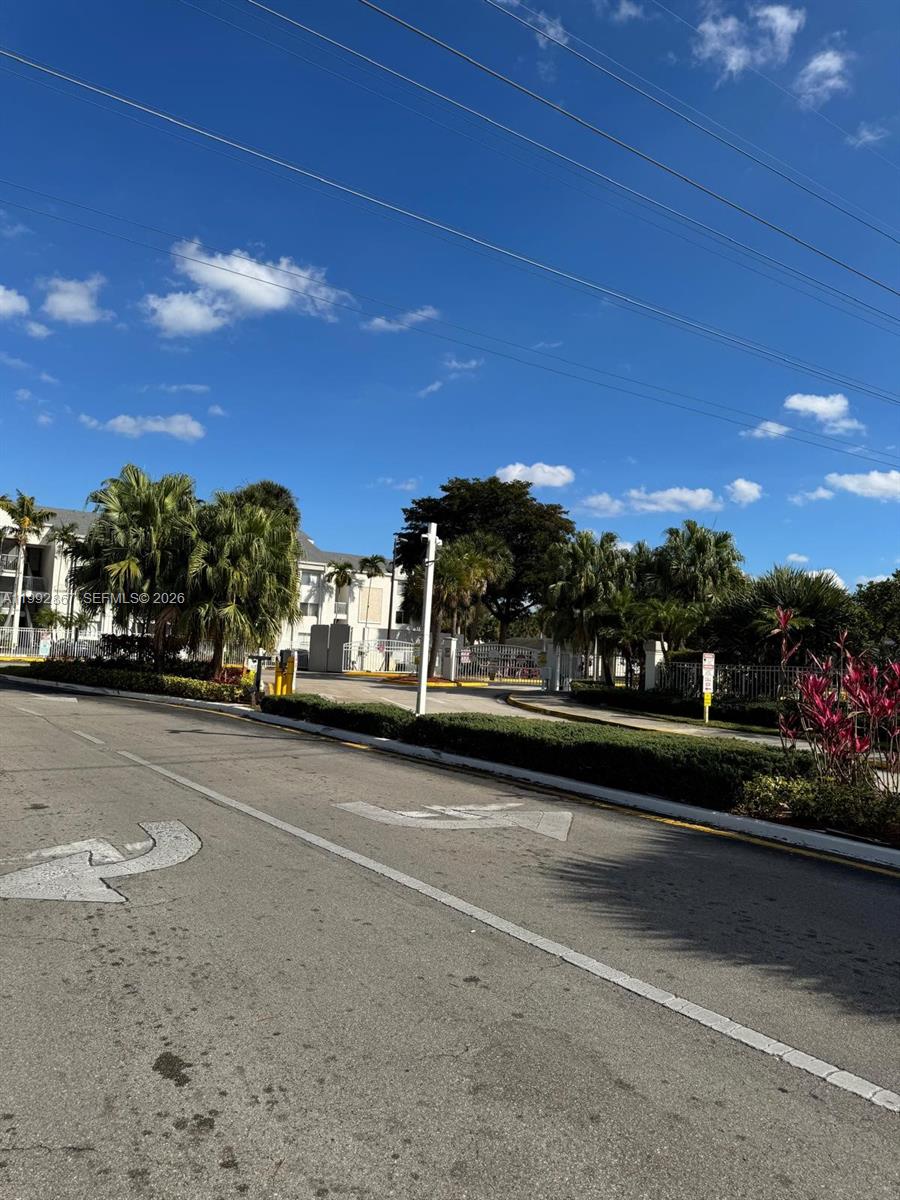 5760 Rock Island Road, Unit 304 Tamarac, FL 33319 - Photo 39 of 40 a view of city street with a car parked on the road