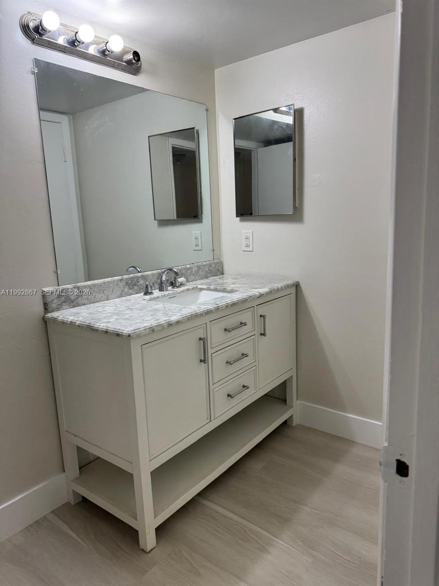 5760 Rock Island Road, Unit 304 Tamarac, FL 33319 - Photo 8 of 40 a bathroom with a double vanity sink and mirror