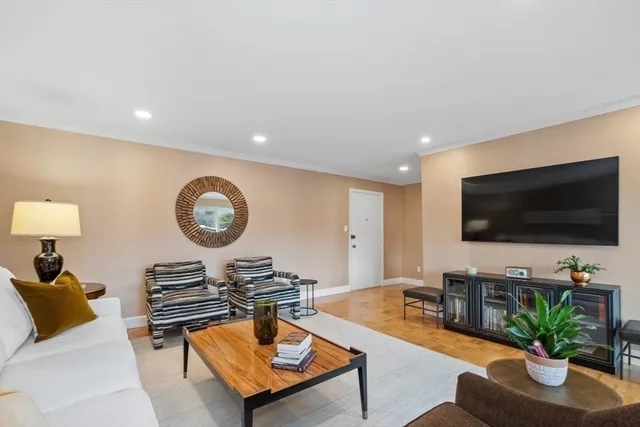 a kitchen with granite countertop a sink stainless steel appliances and white cabinets