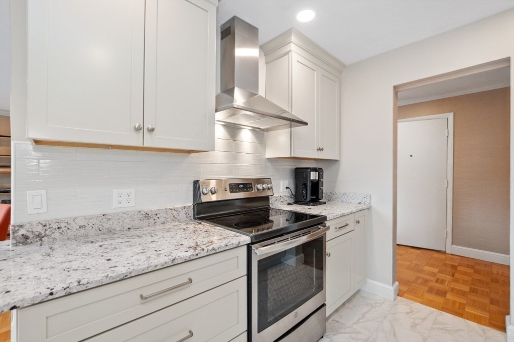 1202 Greendale Avenue, Unit 133 Needham, MA 02492 - Photo 16 of 25 a kitchen with granite countertop a stove and a sink
