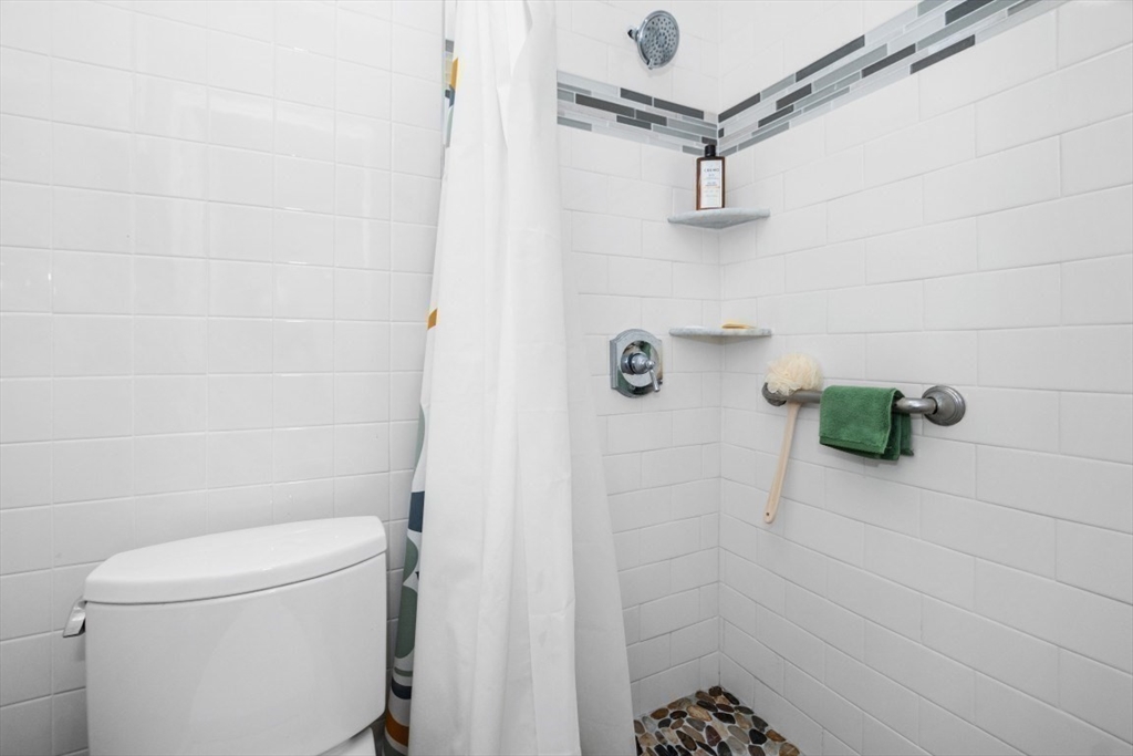 1202 Greendale Avenue, Unit 133 Needham, MA 02492 - Photo 19 of 25 a bathroom with a shower and a toilet