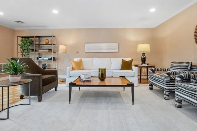 a living room with furniture and a lamp