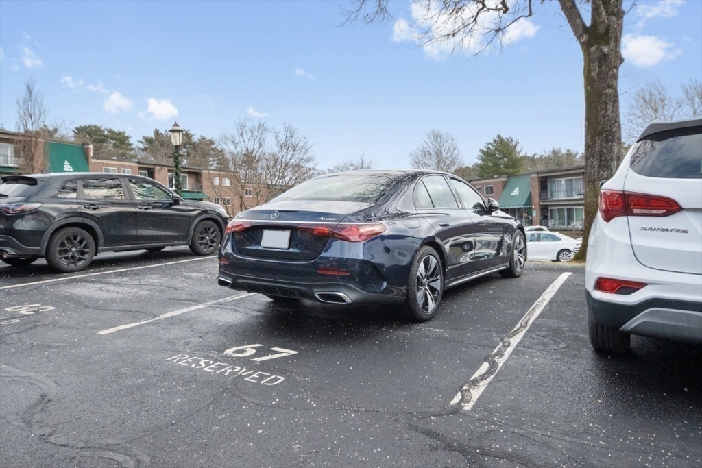 1202 Greendale Avenue, Unit 133 Needham, MA 02492 - Photo 25 of 25 a view of a cars park in front of a house