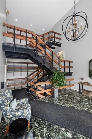 a dining room with furniture and a floor to ceiling window