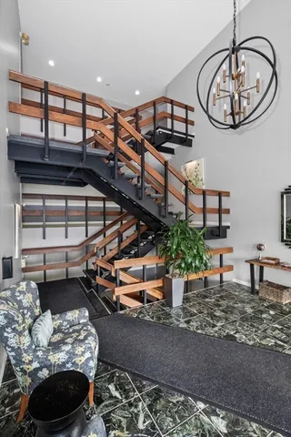 a living room with furniture and a chandelier