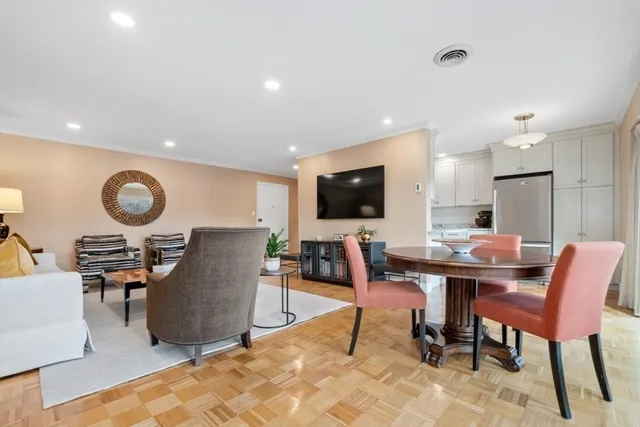 a work room with furniture a flat screen tv and a window