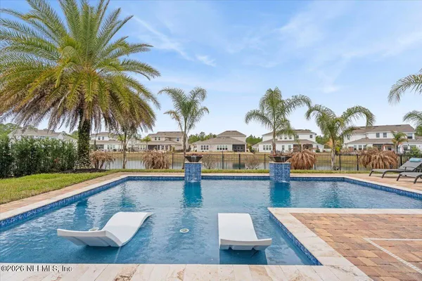 a view of a swimming pool with lounge chair