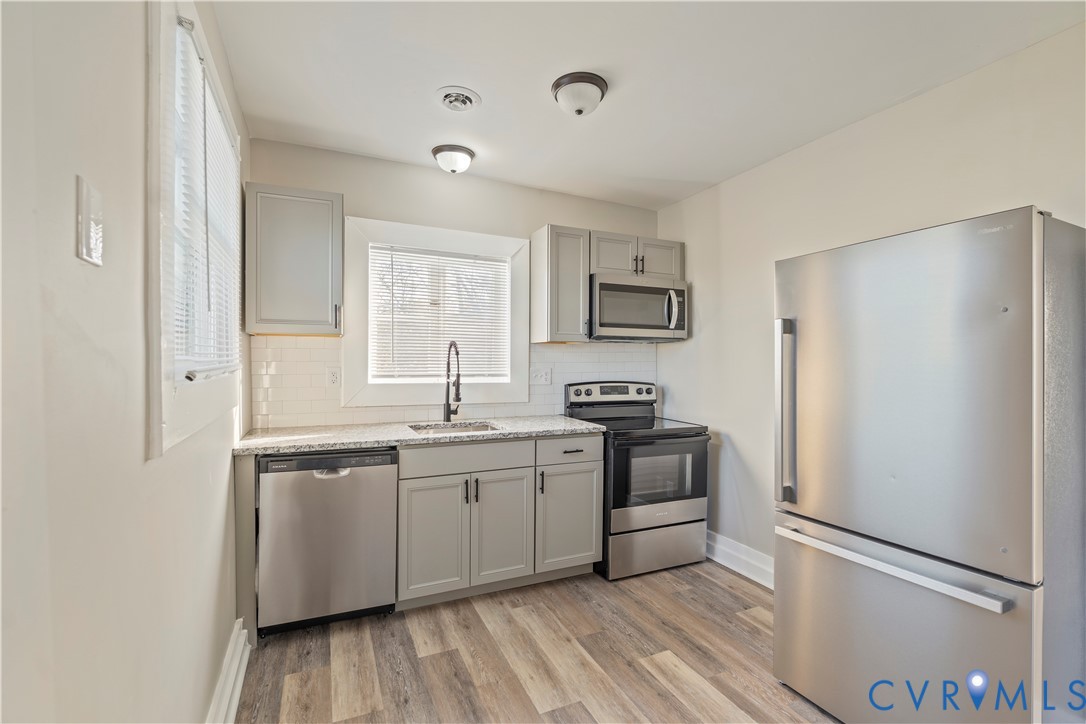 22 Corling Street Petersburg, VA 23803 - Photo 12 of 16 Kitchen featuring gray cabinets, appliances with s
