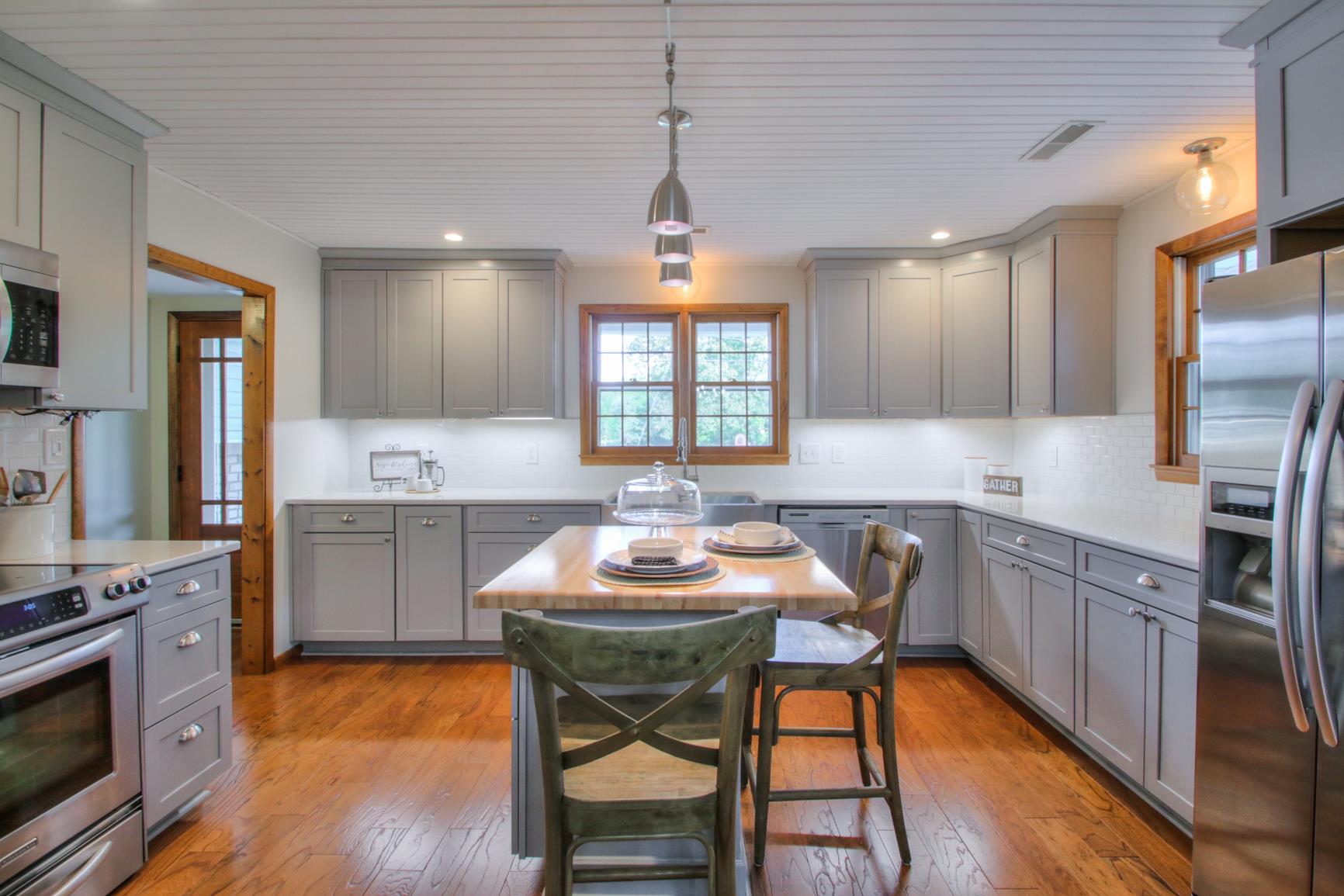 Stunning, fully remodeled kitchen with soft-close cabinets, quartz counters and subway tile backsplash!