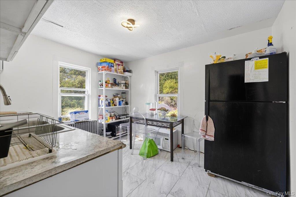 67 Main Street Bloomingburg, NY 12721 - Photo 6 of 29 a kitchen with a refrigerator and a sink