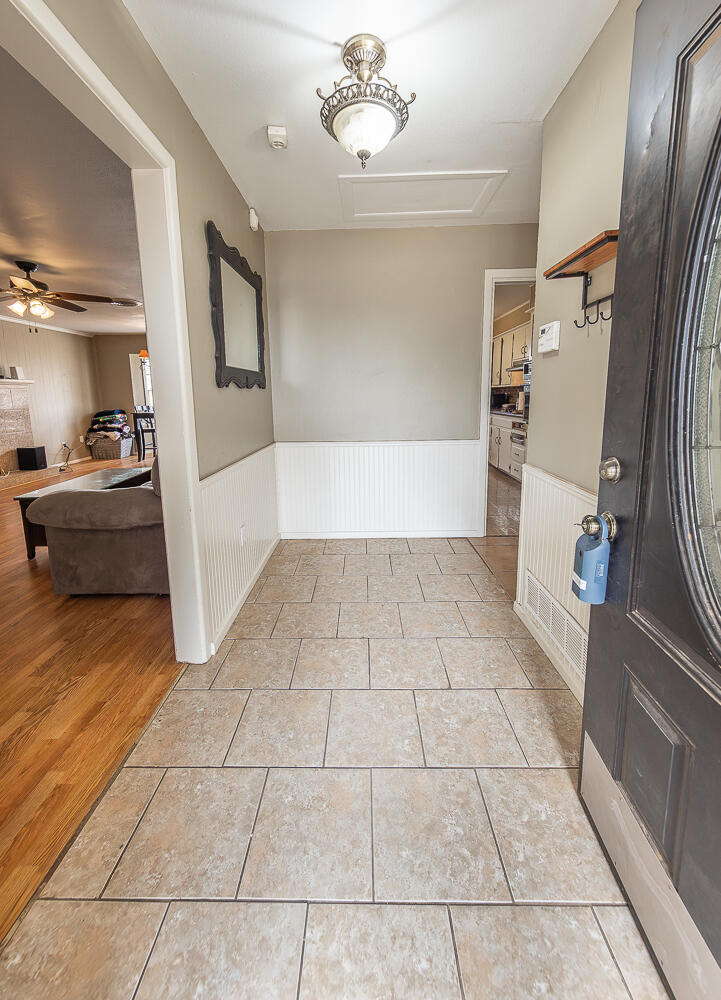 4604 31st Street Lubbock, TX 79410 - Photo 2 of 25 a view of a refrigerator in kitchen and entryway with furniture