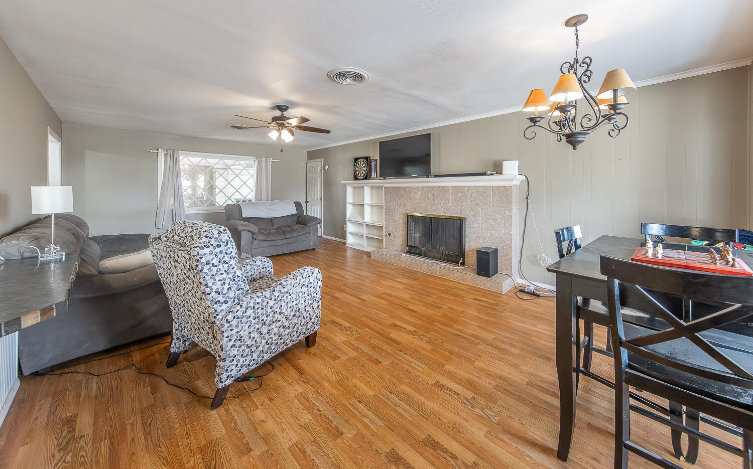 4604 31st Street Lubbock, TX 79410 - Photo 6 of 25 a living room with furniture a fireplace and a chandelier