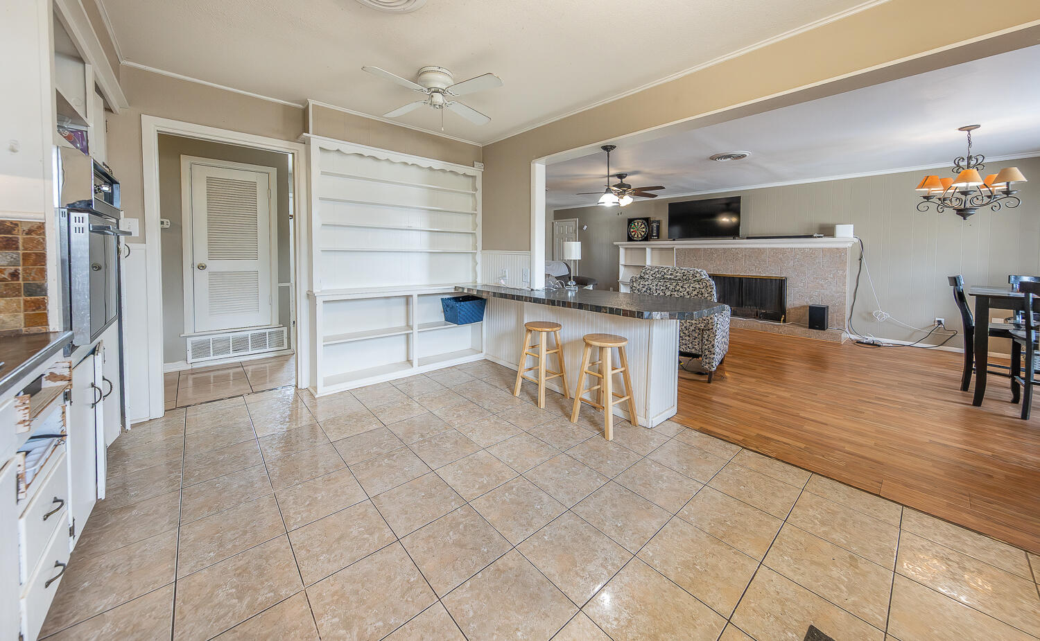 4604 31st Street Lubbock, TX 79410 - Photo 9 of 25 a living room with stainless steel appliances kitchen island granite countertop furniture and a kitchen view