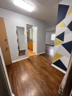 a view of an entryway with wooden floor