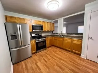 a kitchen with stainless steel appliances granite countertop a refrigerator a stove top oven a sink and dishwasher