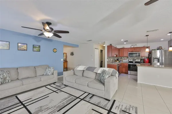 a living room with furniture and kitchen view
