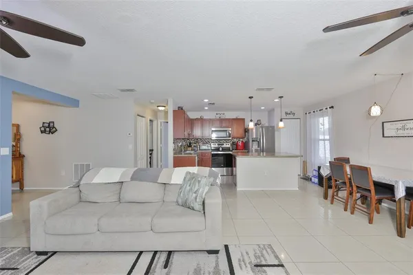 a living room with furniture and kitchen view