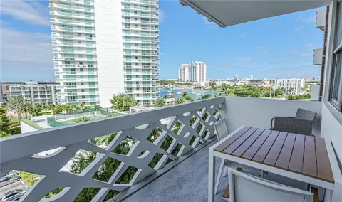 a view of balcony with wooden floor and outdoor seating