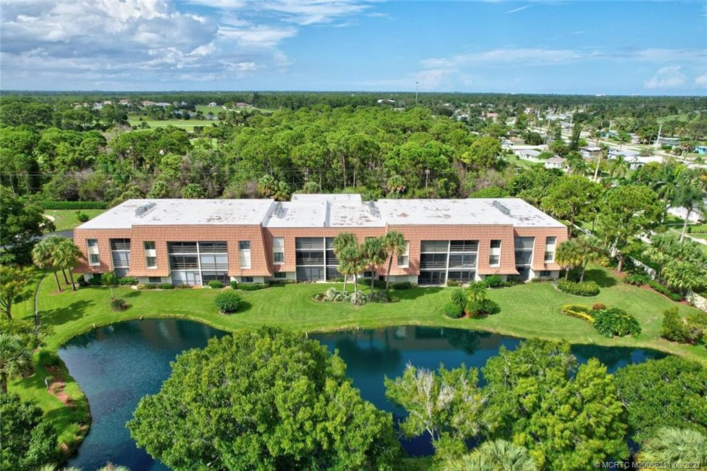 3100 Southeast Pruitt Road, Unit B102 Port St. Lucie, FL 34952 - Photo 1 of 55 a front view of a house with a yard