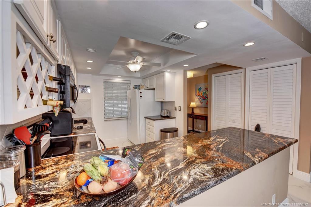 3100 Southeast Pruitt Road, Unit B102 Port St. Lucie, FL 34952 - Photo 15 of 55 a view of a kitchen and dining room