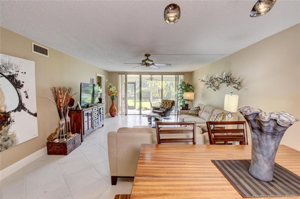 3100 Southeast Pruitt Road, Unit B102 Port St. Lucie, FL 34952 - Photo 19 of 55 a living room with furniture and wooden floor