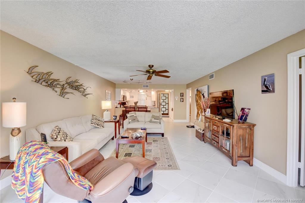 3100 Southeast Pruitt Road, Unit B102 Port St. Lucie, FL 34952 - Photo 20 of 55 a living room with furniture and a flat screen tv