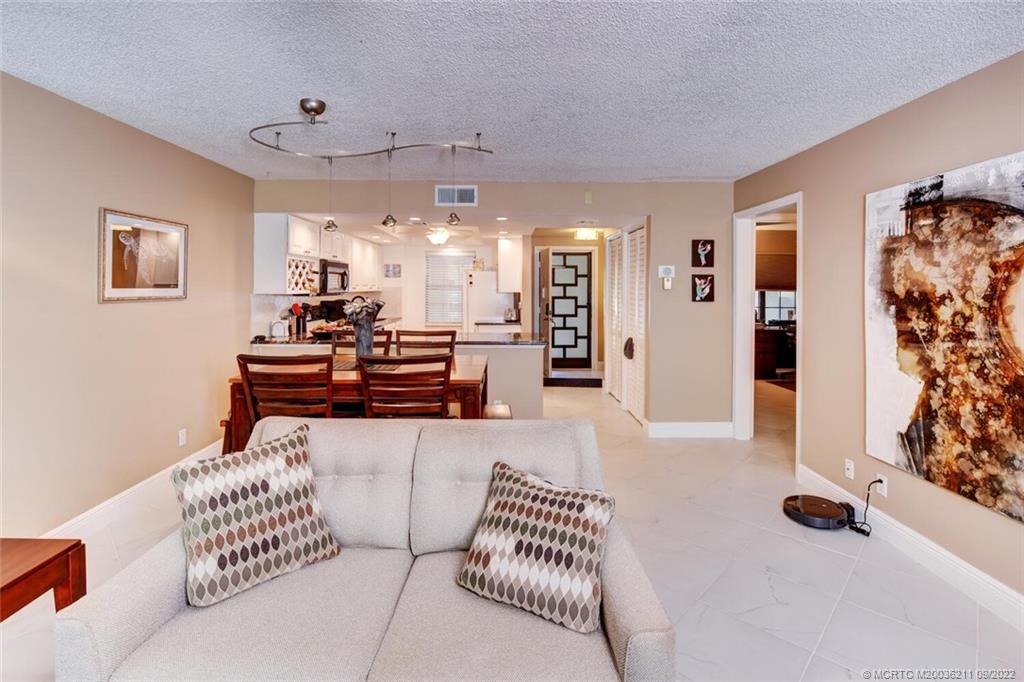 3100 Southeast Pruitt Road, Unit B102 Port St. Lucie, FL 34952 - Photo 22 of 55 a living room with furniture and a chandelier