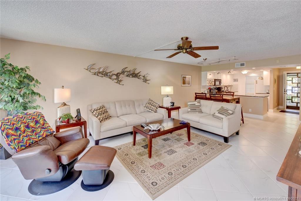 3100 Southeast Pruitt Road, Unit B102 Port St. Lucie, FL 34952 - Photo 23 of 55 a living room with furniture and wooden floor