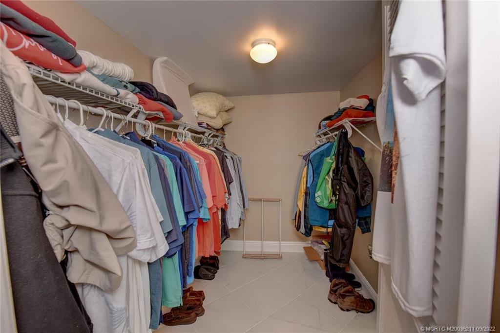 3100 Southeast Pruitt Road, Unit B102 Port St. Lucie, FL 34952 - Photo 28 of 55 a view of walk in closet with clothes