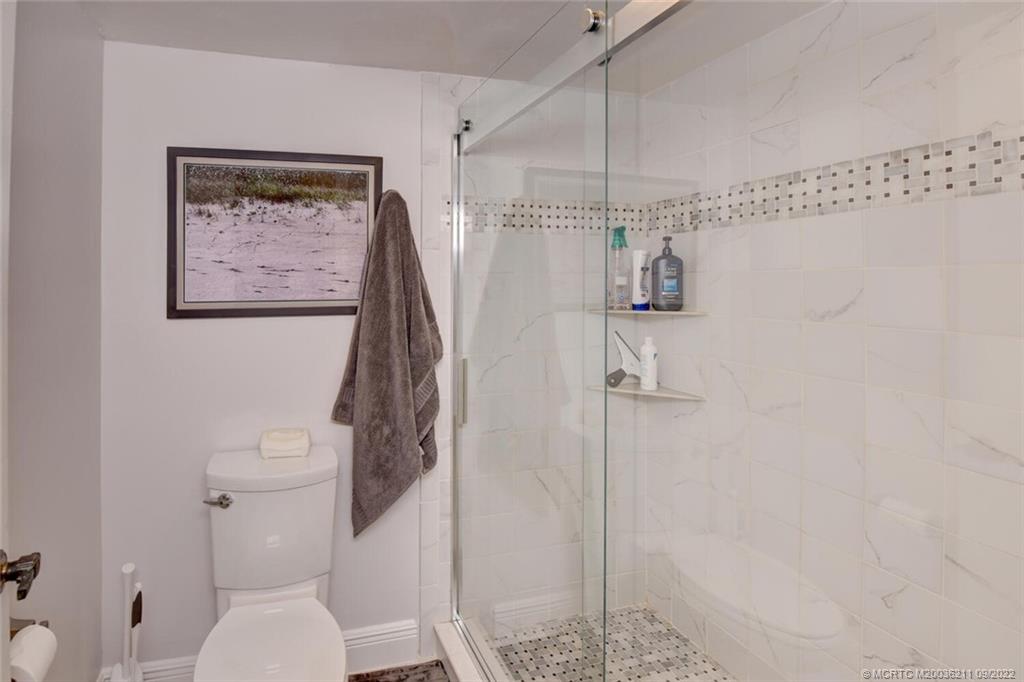 3100 Southeast Pruitt Road, Unit B102 Port St. Lucie, FL 34952 - Photo 29 of 55 a bathroom with a toilet and a shower