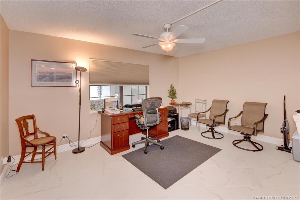 3100 Southeast Pruitt Road, Unit B102 Port St. Lucie, FL 34952 - Photo 35 of 55 a view of a workspace with furniture and a window