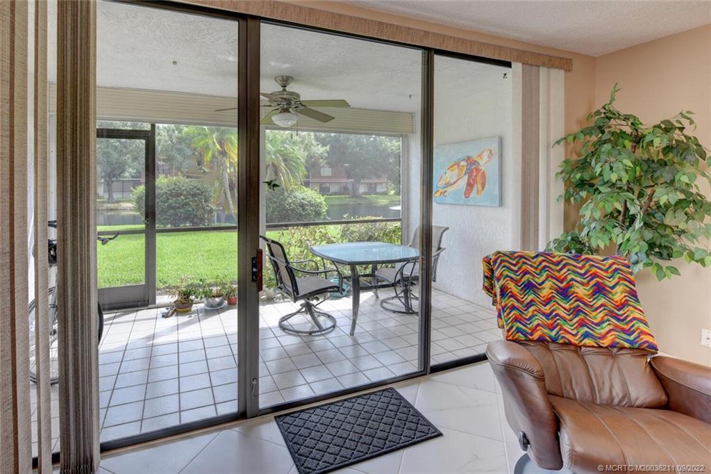 3100 Southeast Pruitt Road, Unit B102 Port St. Lucie, FL 34952 - Photo 36 of 55 a living room with a large window and a table