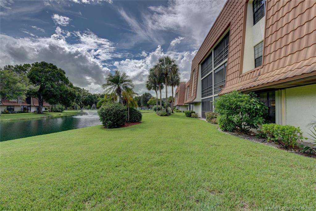 3100 Southeast Pruitt Road, Unit B102 Port St. Lucie, FL 34952 - Photo 39 of 55 a backyard of a house with lots of green space and lake view