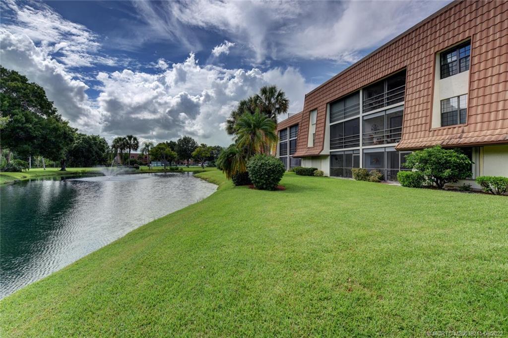 3100 Southeast Pruitt Road, Unit B102 Port St. Lucie, FL 34952 - Photo 40 of 55 a view of a house with a yard and a large tree