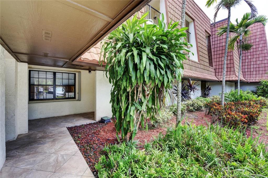 3100 Southeast Pruitt Road, Unit B102 Port St. Lucie, FL 34952 - Photo 4 of 55 a front view of a house with garden