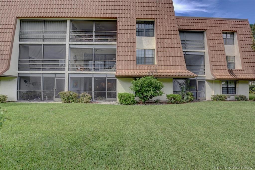 3100 Southeast Pruitt Road, Unit B102 Port St. Lucie, FL 34952 - Photo 41 of 55 a front view of a house with a yard