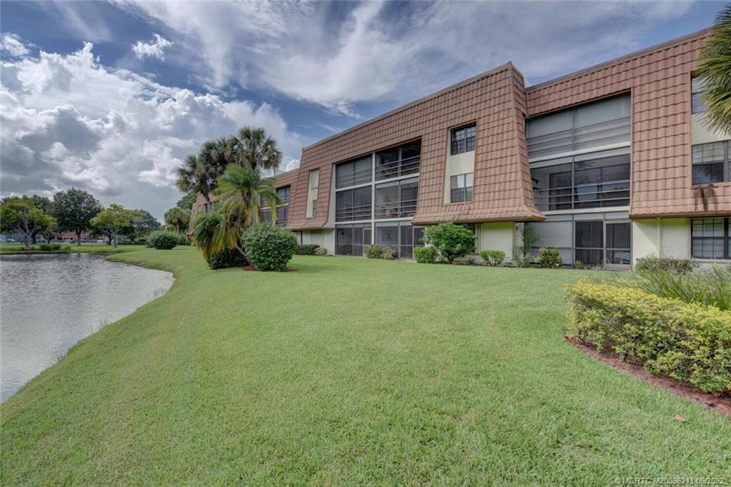 3100 Southeast Pruitt Road, Unit B102 Port St. Lucie, FL 34952 - Photo 42 of 55 a front view of a house with garden