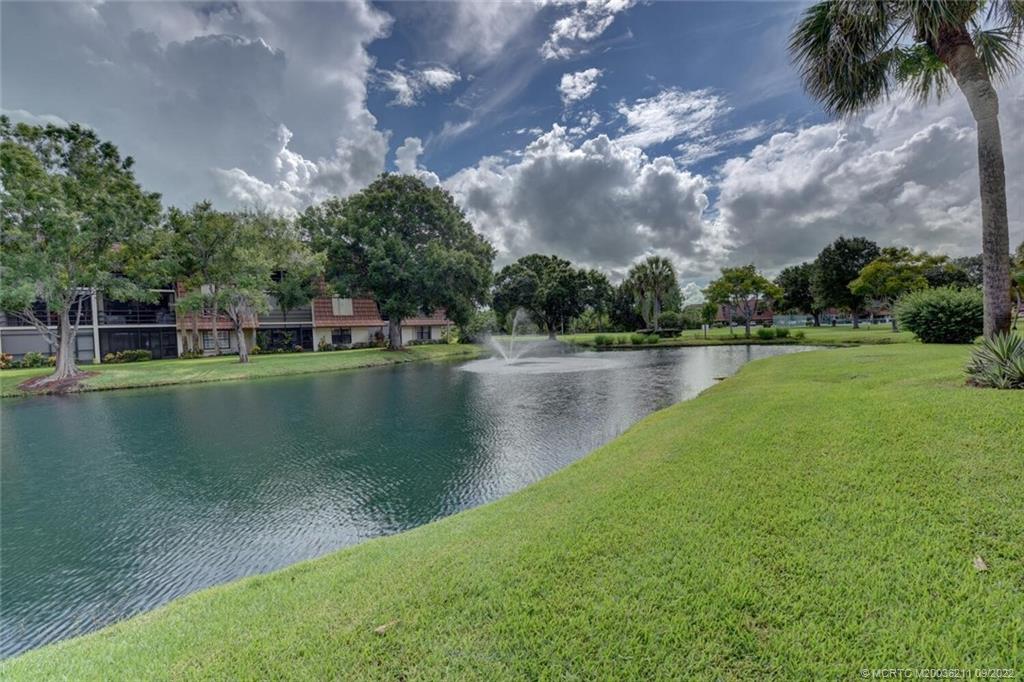 3100 Southeast Pruitt Road, Unit B102 Port St. Lucie, FL 34952 - Photo 43 of 55 a view of a lake with houses in the back