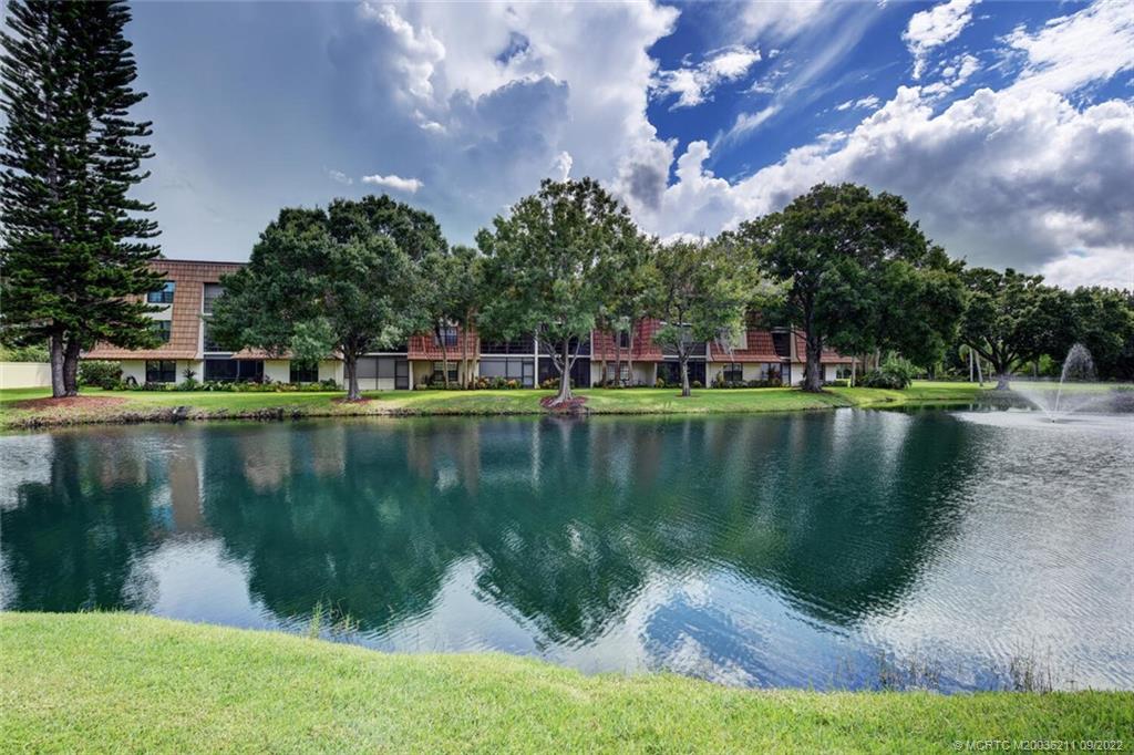 3100 Southeast Pruitt Road, Unit B102 Port St. Lucie, FL 34952 - Photo 44 of 55 a view of a lake with houses in the background