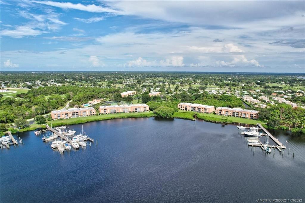 3100 Southeast Pruitt Road, Unit B102 Port St. Lucie, FL 34952 - Photo 53 of 55 a view of a lake with a nearby beach