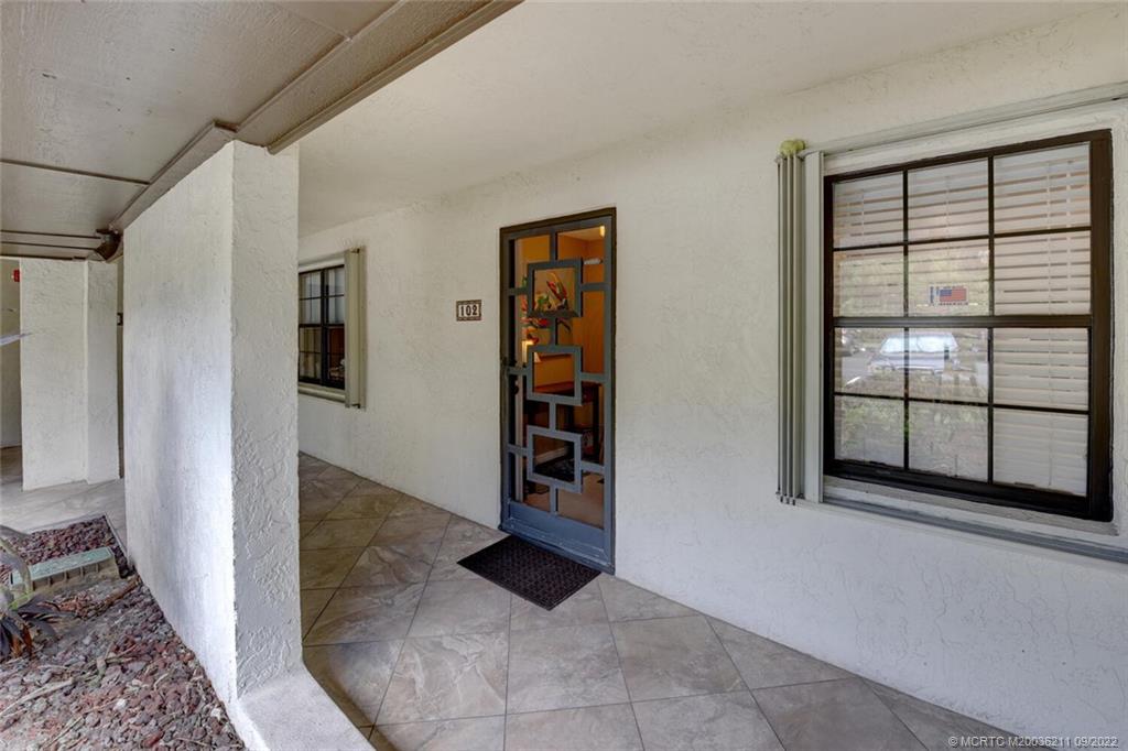 3100 Southeast Pruitt Road, Unit B102 Port St. Lucie, FL 34952 - Photo 6 of 55 a view of an empty room with window and stairs