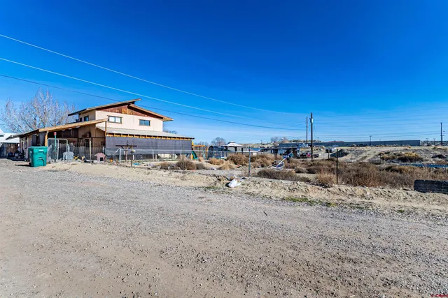 a view of a large lake with a big yard and large trees
