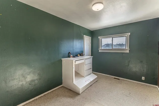 a living room with lots of furniture and white walls
