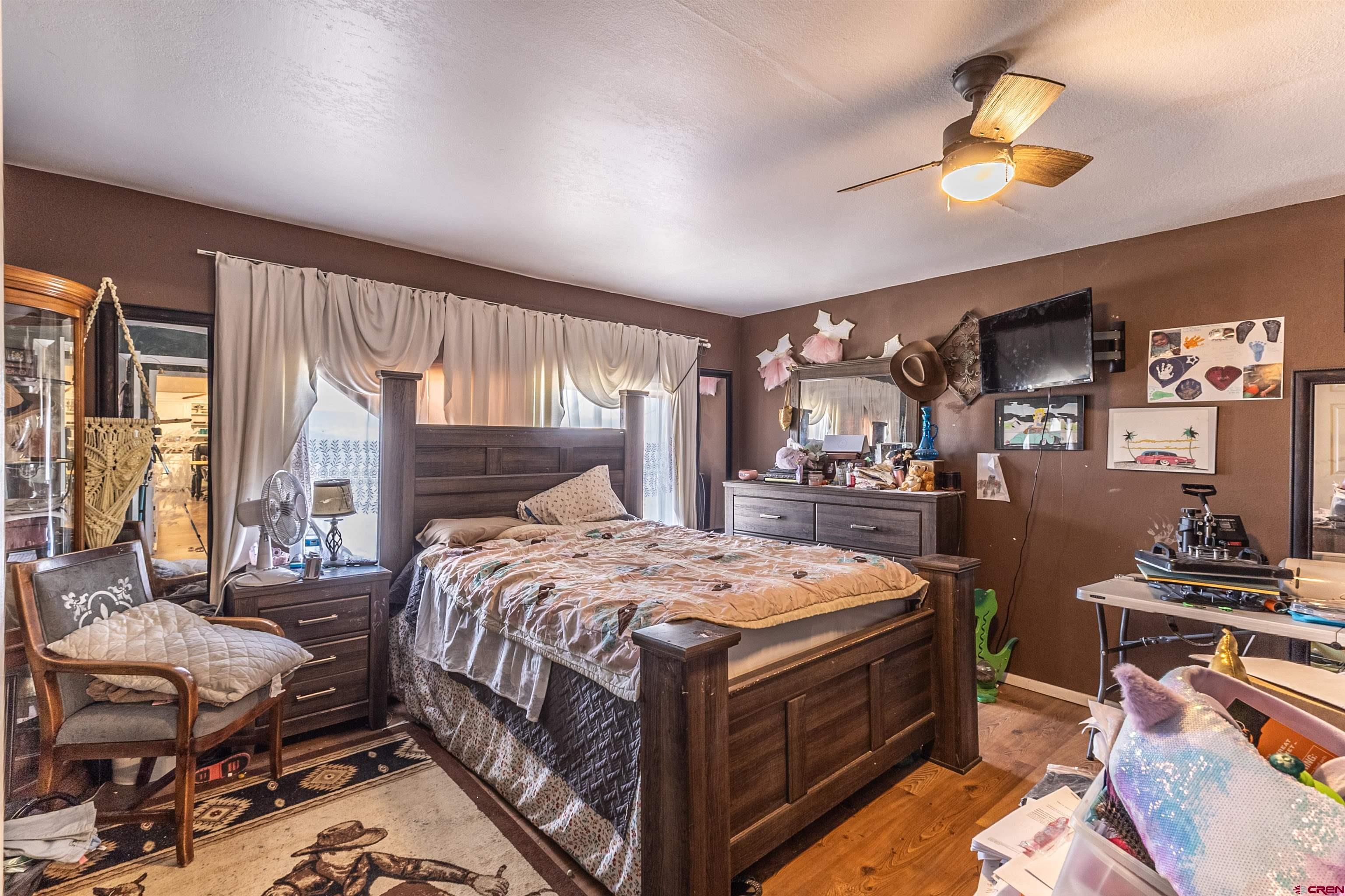 11 Road 3003 Aztec, NM 87410 - Photo 28 of 38 a bed room with a bed and a chandelier