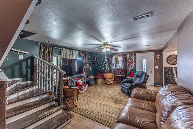 a living room with furniture and a chandelier