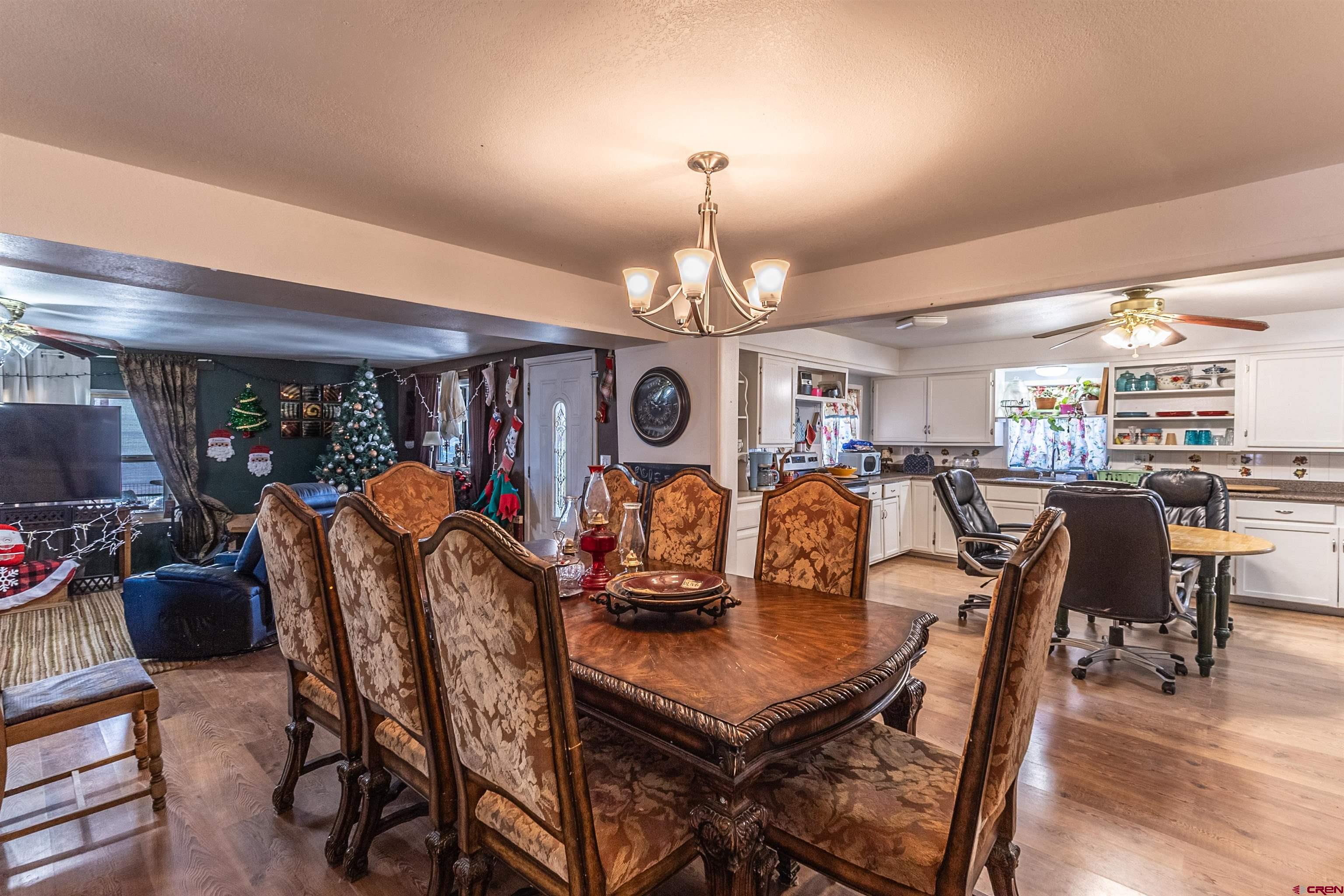 11 Road 3003 Aztec, NM 87410 - Photo 33 of 38 a view of a dining room with furniture a kitchen and chandelier