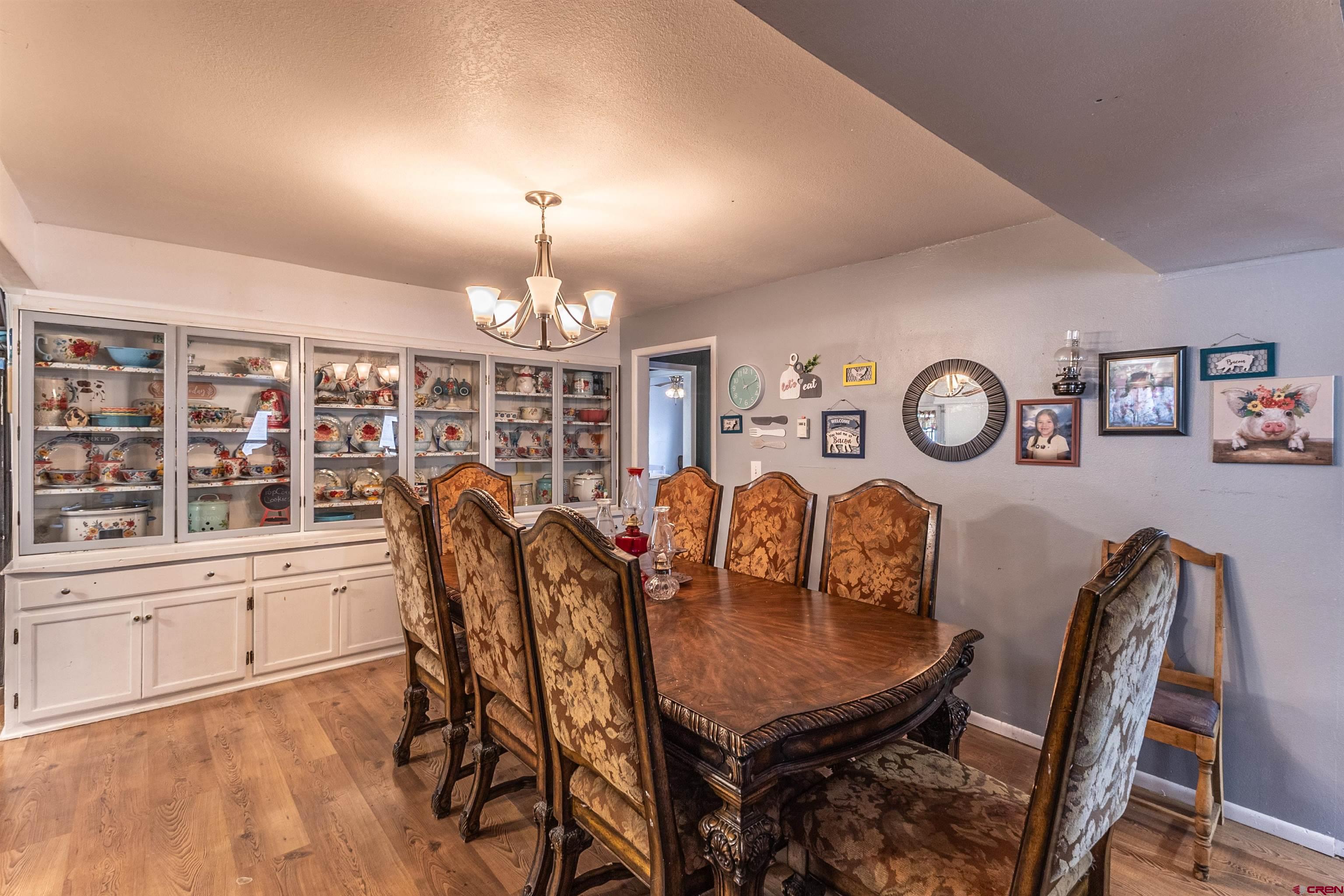 11 Road 3003 Aztec, NM 87410 - Photo 35 of 38 a view of a dining room with furniture window and wooden floor