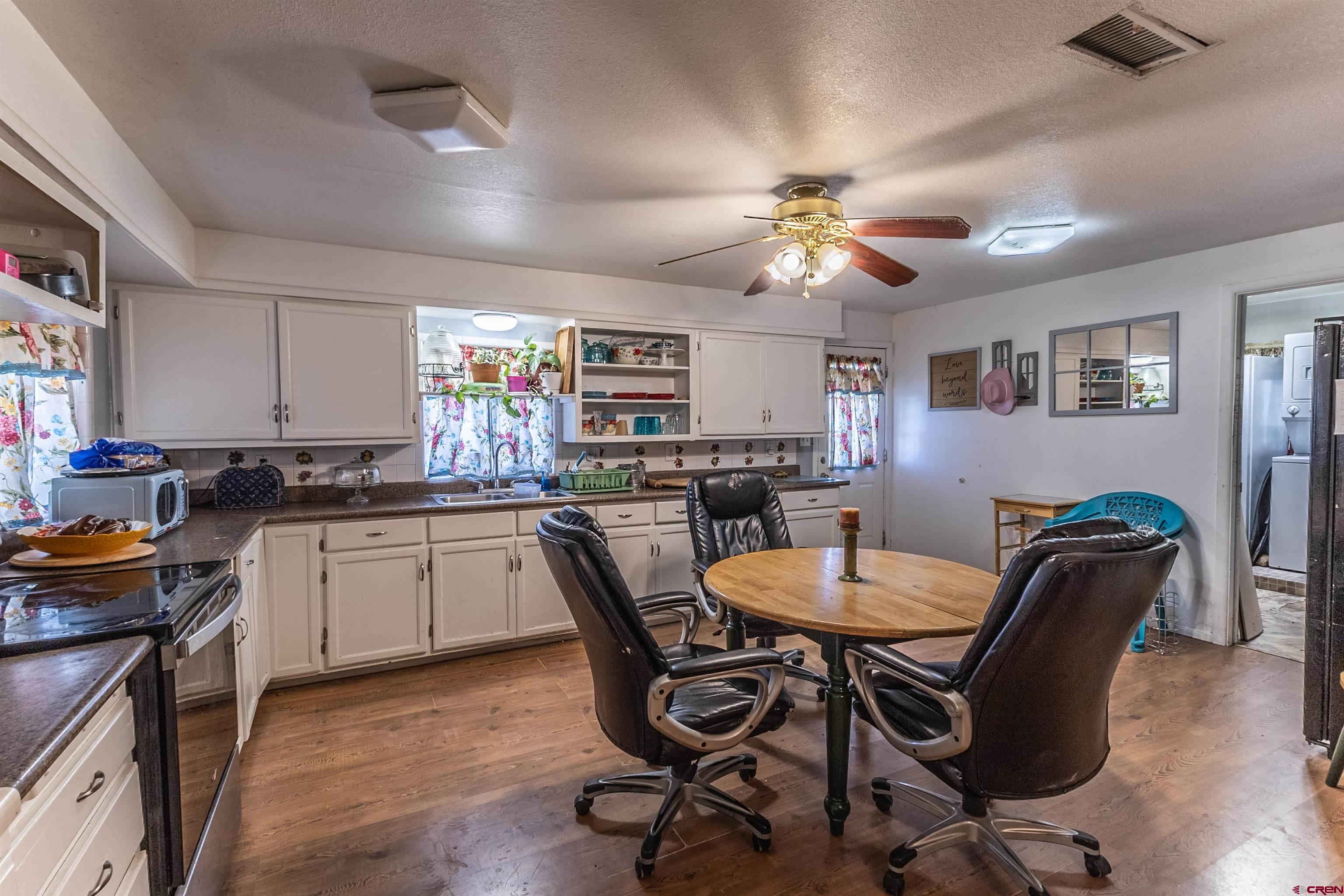 11 Road 3003 Aztec, NM 87410 - Photo 36 of 38 a kitchen with stainless steel appliances granite countertop a dining table chairs and a refrigerator