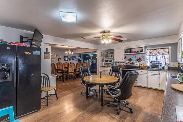 a kitchen with kitchen island granite countertop a sink cabinets and wooden floor